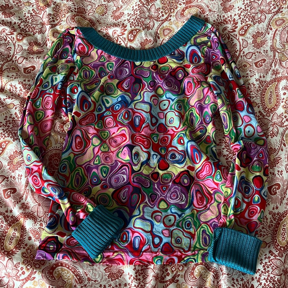 Funky rainbow swirl patterned top with blue knit trim